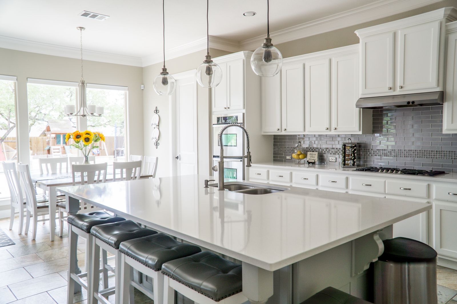 A bright, modern kitchen with an island and quartz worktops