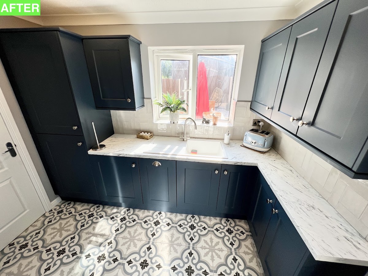 A navy shaker kitchen makeover with marble-effect worktops, chrome cup handles and a bold patterned floor tile — a striking before-and-after.